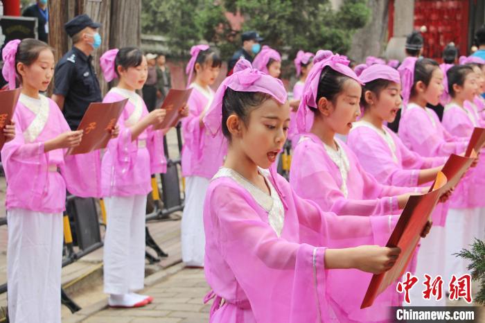 身著古代服飾的小學(xué)生誦讀孟子名言?！≮w曉 攝
