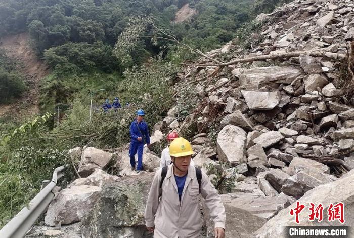 電力搶險(xiǎn)人員徒步通過垮塌路段。　四川電力供圖