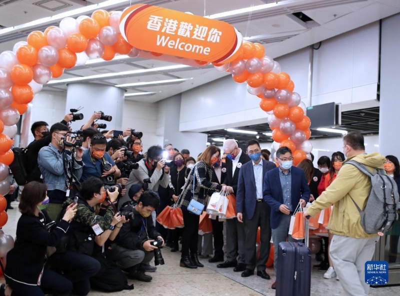 1月15日，在香港的西九龍站，工作人員迎接恢復(fù)通車后內(nèi)地駛往香港首趟列車的旅客并贈(zèng)送小禮物。新華社記者 李鋼 攝