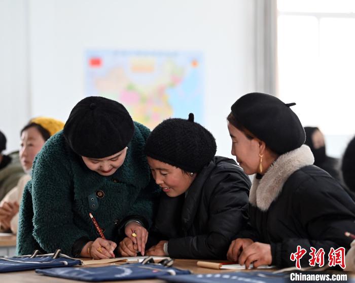 圖為甘肅廣河縣莊窠集鎮(zhèn)婦女，在老師指導(dǎo)下學(xué)習(xí)拼音。　九美旦增 攝